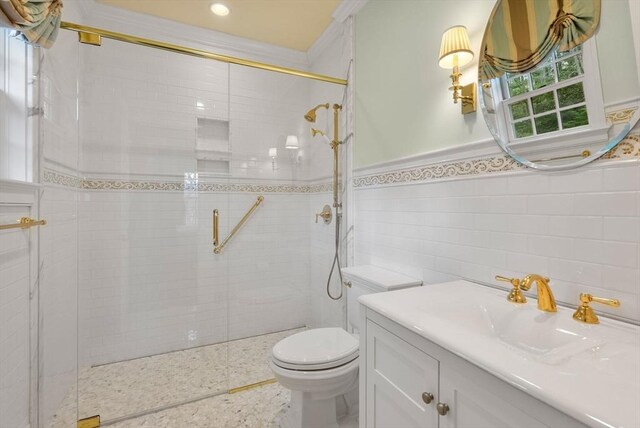 bathroom featuring walk in shower, vanity, toilet, and tile walls