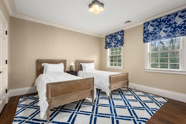 bedroom with crown molding and hardwood / wood-style floors