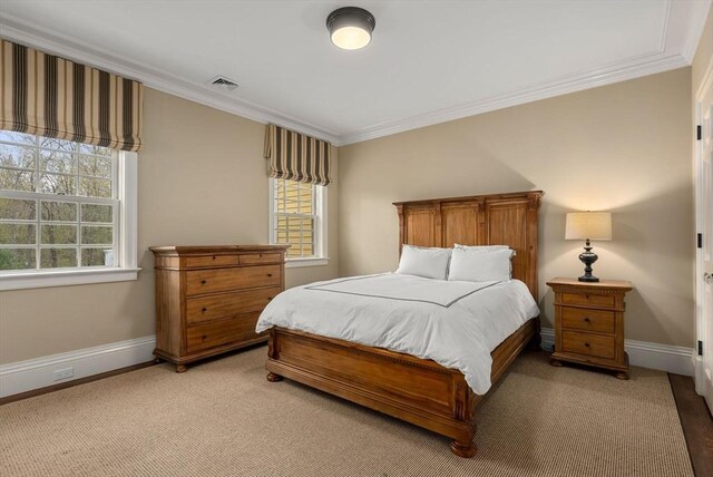 carpeted bedroom featuring ornamental molding