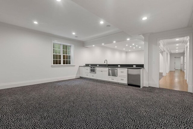 kitchen featuring sink, crown molding, carpet floors, and fridge