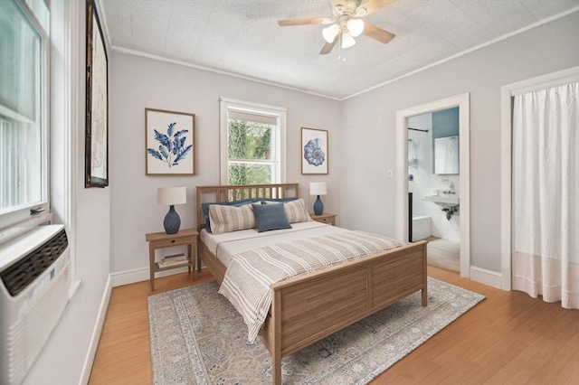 993 Shirley St, Winthrop, MA 02152 - bedroom featuring light wood-type flooring, crown molding, a wall mounted air conditioner, baseboards, and ensuite bath