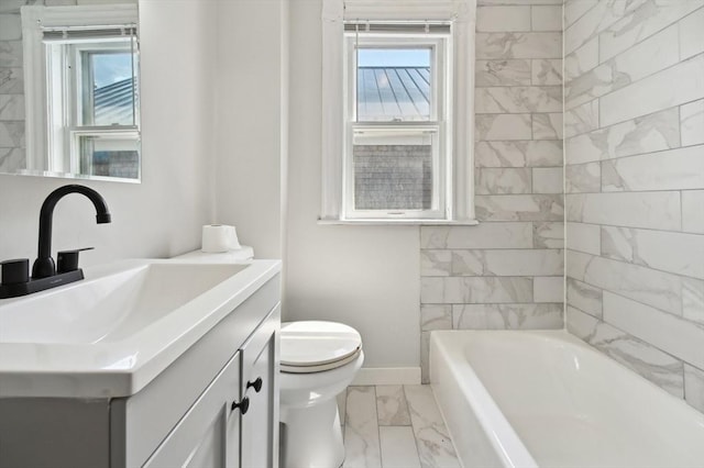 993 Shirley St, Winthrop, MA 02152 - full bath with marble finish flooring, toilet, a tub to relax in, vanity, and baseboards