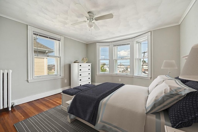 993 Shirley St, Winthrop, MA 02152 - bedroom with dark wood-type flooring, radiator heating unit, baseboards, multiple windows, and crown molding