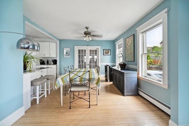 993 Shirley St, Winthrop, MA 02152 - dining area featuring a baseboard heating unit, french doors, a ceiling fan, light wood-style floors, and baseboards