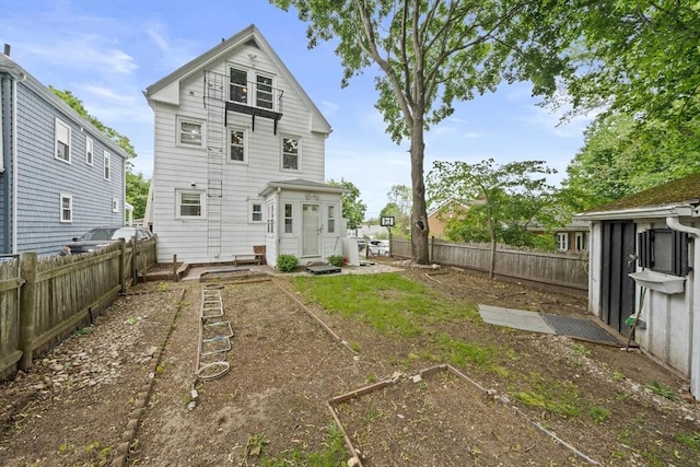 26 Sherman Rd, Braintree, MA 02184 - rear view of house with a fenced backyard