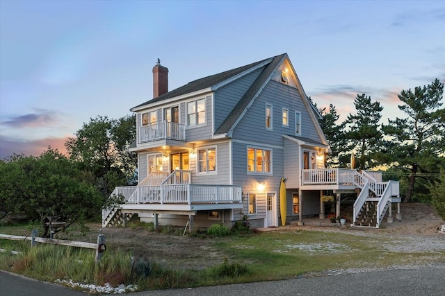 24 Old Point Rd, Newbury, MA 01951 - back of property with stairway, a balcony, a chimney, and a deck
