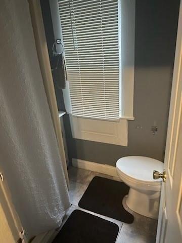 bathroom with tile patterned flooring and toilet