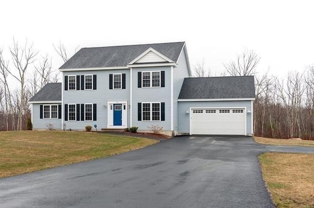 view of front of house featuring a front yard and a garage