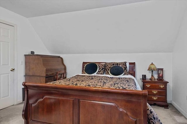 carpeted bedroom featuring vaulted ceiling