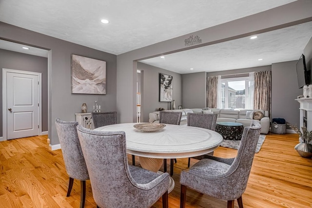 dining area featuring light wood-type flooring, recessed lighting, and baseboards