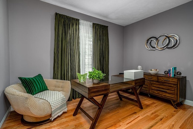 office featuring light wood-type flooring and baseboards