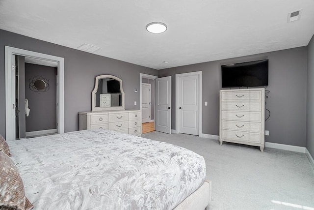 bedroom with baseboards and light colored carpet