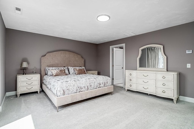 bedroom with light carpet and baseboards