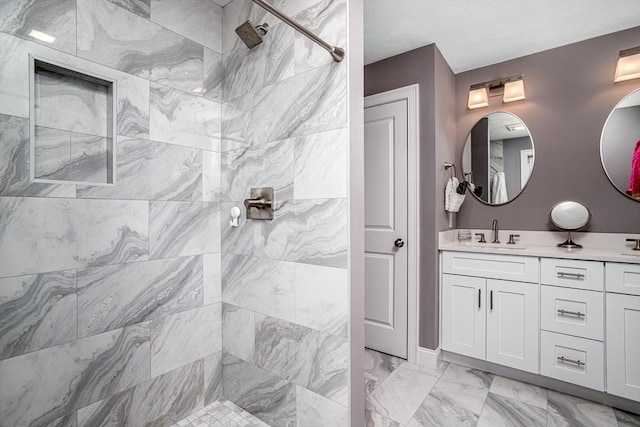 full bath with tiled shower, marble look tiles, and vanity