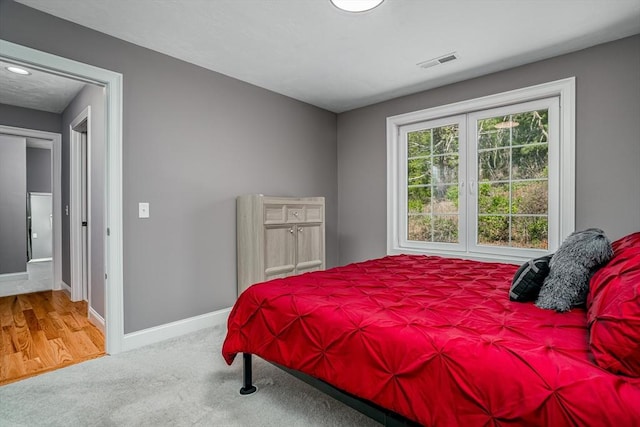 bedroom featuring baseboards and carpet