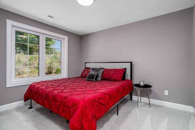 carpeted bedroom with baseboards