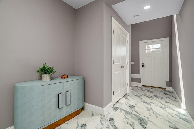 entryway featuring marble look tiles, baseboards, and recessed lighting