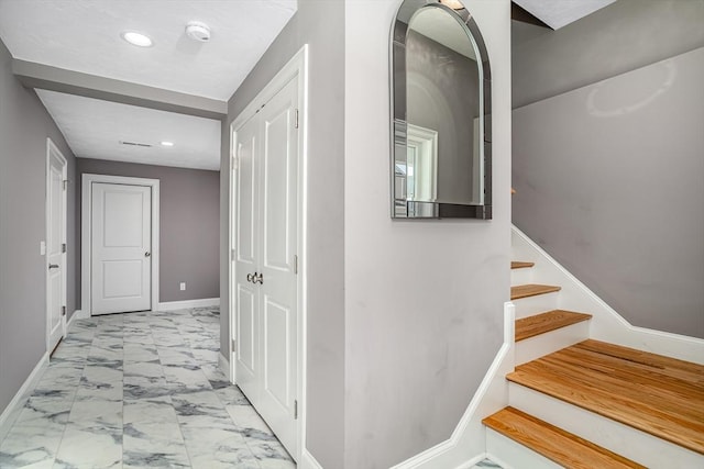 hallway with marble look tiles, recessed lighting, baseboards, and stairway