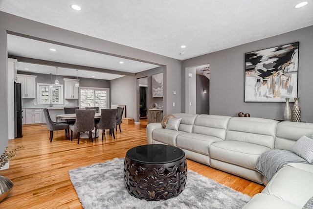 living room with recessed lighting and light wood-style flooring
