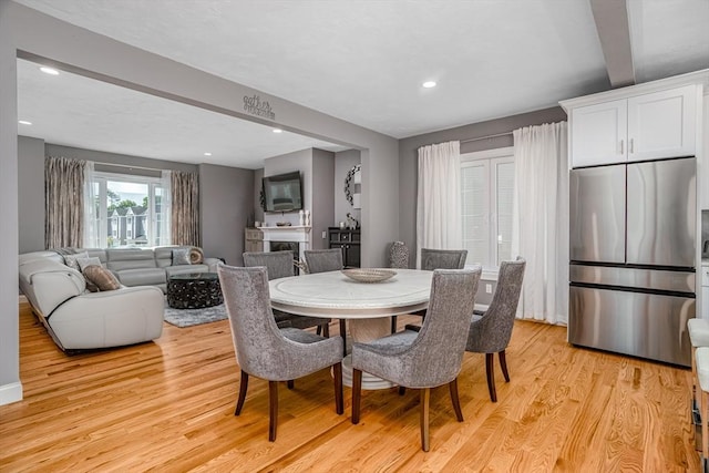dining space with light wood-type flooring, beam ceiling, and recessed lighting
