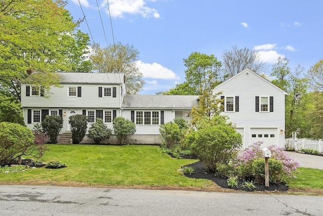 colonial home featuring an attached garage and driveway