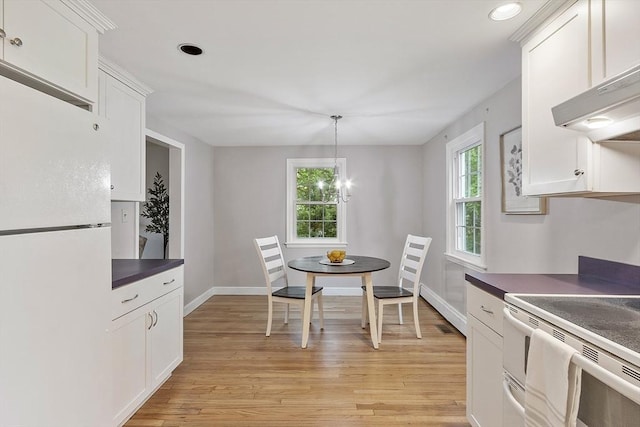 dining space with plenty of natural light, light wood-type flooring, baseboards, and recessed lighting