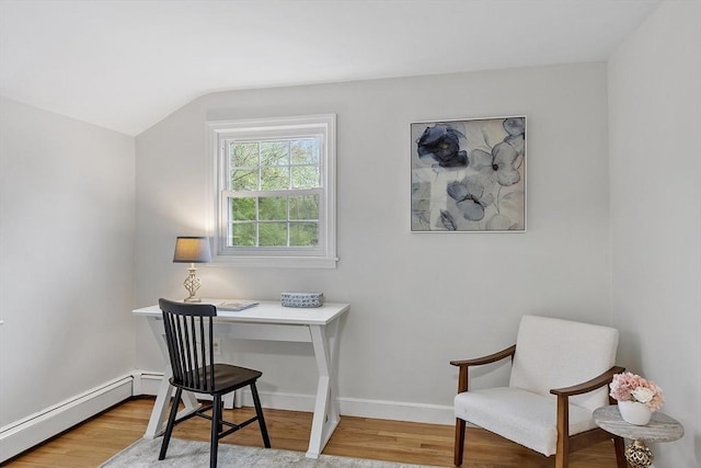 home office featuring light wood finished floors, lofted ceiling, a baseboard heating unit, and baseboards