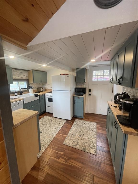 134 Kibbe Rd, Otis, MA 01029 - kitchen with dark wood-style flooring, white appliances, tasteful backsplash, and a sink
