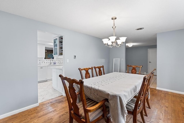 47 Churchill St, Sudbury, MA 01776 - dining room featuring a chandelier and light wood-type flooring