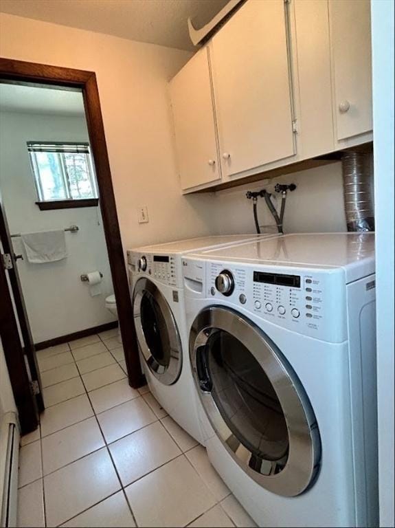 47 Churchill St, Sudbury, MA 01776 - laundry room with washing machine and clothes dryer, cabinet space, baseboard heating, and light tile patterned flooring