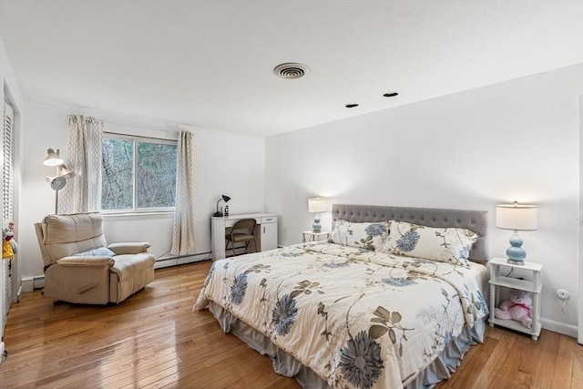 47 Churchill St, Sudbury, MA 01776 - bedroom featuring wood-type flooring and a baseboard heating unit