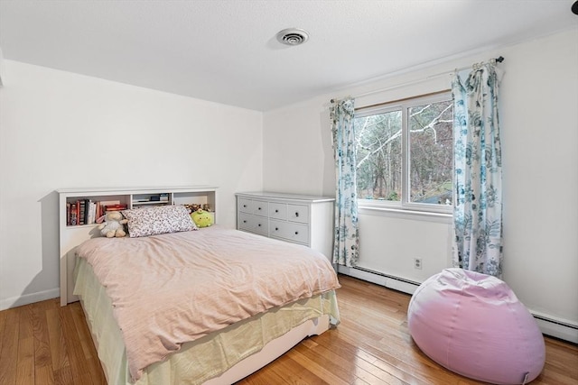 47 Churchill St, Sudbury, MA 01776 - bedroom with a baseboard radiator and wood finished floors