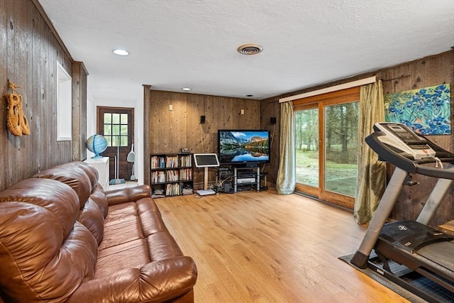 47 Churchill St, Sudbury, MA 01776 - living area featuring wood walls, wood finished floors, recessed lighting, and a textured ceiling
