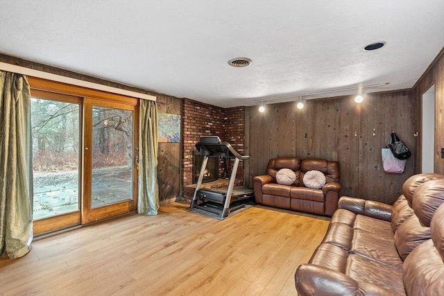 47 Churchill St, Sudbury, MA 01776 - exercise room with wooden walls, light wood-type flooring, and rail lighting