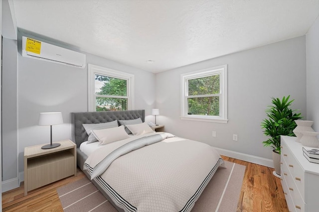 13 Hickory Rd, Halifax, MA 02338 - bedroom with a wall mounted AC and light wood finished floors