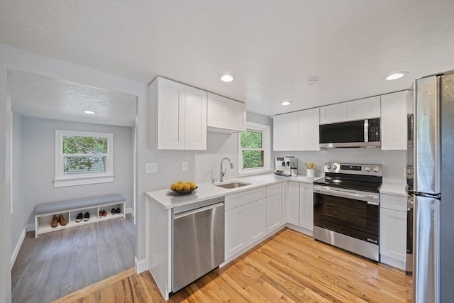 13 Hickory Rd, Halifax, MA 02338 - kitchen with appliances with stainless steel finishes, white cabinets, light countertops, light wood finished floors, and recessed lighting