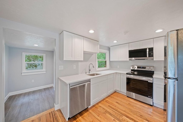 13 Hickory Rd, Halifax, MA 02338 - kitchen featuring stainless steel appliances, white cabinetry, light countertops, light wood-type flooring, and recessed lighting