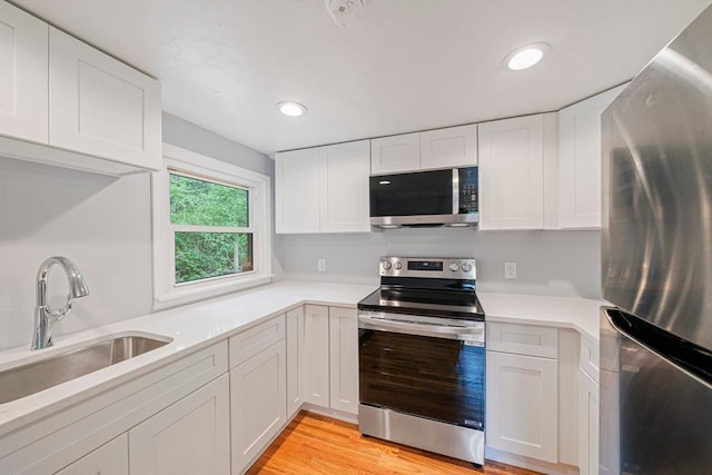13 Hickory Rd, Halifax, MA 02338 - kitchen with appliances with stainless steel finishes, light countertops, white cabinets, light wood-style flooring, and recessed lighting