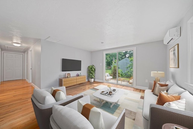 13 Hickory Rd, Halifax, MA 02338 - living area featuring a wall mounted AC and light wood finished floors