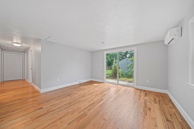 13 Hickory Rd, Halifax, MA 02338 - spare room with a wall mounted AC, light wood-style floors, and attic access
