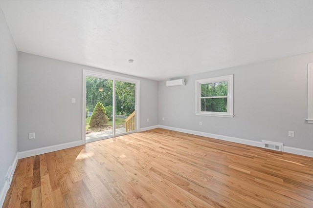 13 Hickory Rd, Halifax, MA 02338 - spare room with an AC wall unit, healthy amount of natural light, and light wood-type flooring