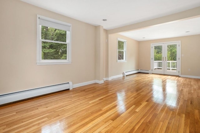 35 Faulkner Hill Rd, Acton, MA 01720 - empty room featuring healthy amount of natural light, light wood-style floors, french doors, and baseboard heating