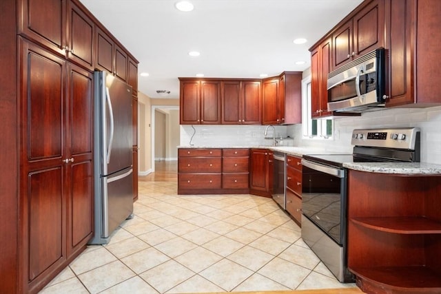 35 Faulkner Hill Rd, Acton, MA 01720 - kitchen featuring stainless steel appliances, decorative backsplash, light tile patterned flooring, light stone counters, and dark brown cabinets