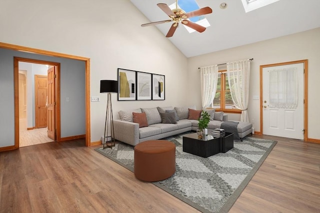 35 Faulkner Hill Rd, Acton, MA 01720 - living area with a ceiling fan, wood finished floors, high vaulted ceiling, a skylight, and a baseboard radiator