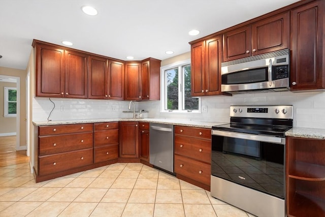 35 Faulkner Hill Rd, Acton, MA 01720 - kitchen with stainless steel appliances, backsplash, light stone counters, recessed lighting, and light tile patterned floors