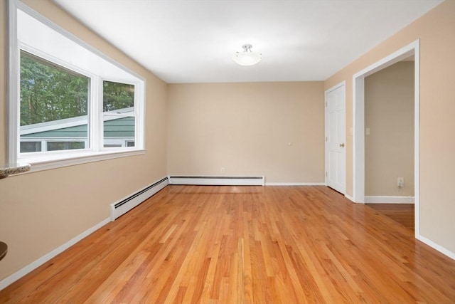 35 Faulkner Hill Rd, Acton, MA 01720 - empty room featuring a baseboard heating unit and light wood-style floors