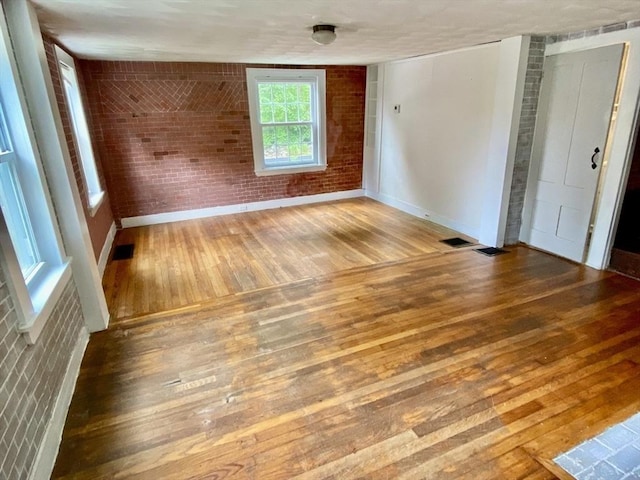 387 W Washington St, Hanson, MA 02341 - unfurnished room featuring hardwood / wood-style flooring and brick wall