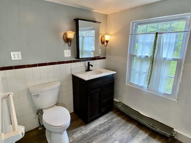 387 W Washington St, Hanson, MA 02341 - bathroom featuring tile walls, wood finished floors, vanity, and healthy amount of natural light
