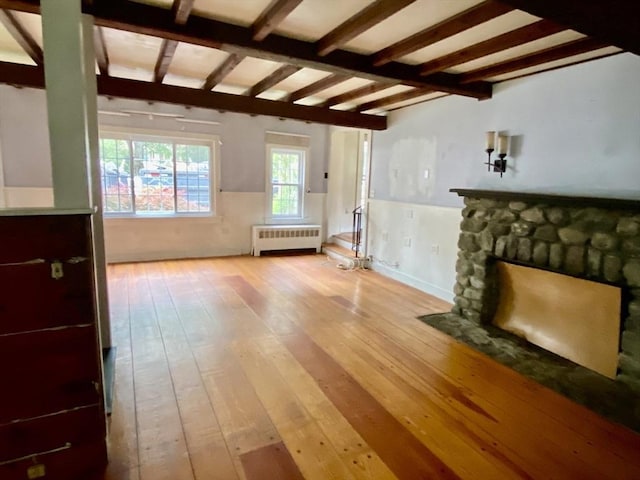 387 W Washington St, Hanson, MA 02341 - unfurnished living room featuring radiator heating unit, hardwood / wood-style floors, wainscoting, and a fireplace