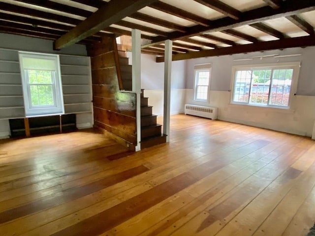 387 W Washington St, Hanson, MA 02341 - spare room with radiator, stairway, hardwood / wood-style flooring, and beam ceiling